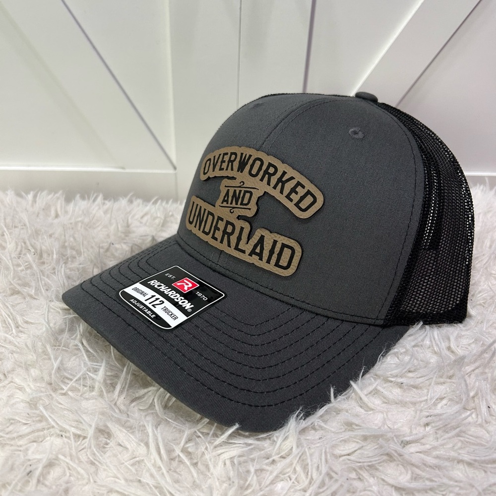 Overworked and underlaid. Trucker Richardson 112 hat.